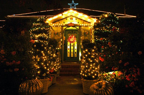 Pumpkins, fairy lights, flowers, topiary, blue star, wreath, front door, at entrance of the Mill Rose Inn, Half Moon Bay, California, USA by Wonderlane