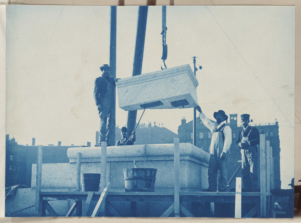 Workmen laying the cornerstone, construction of the McKim Building
