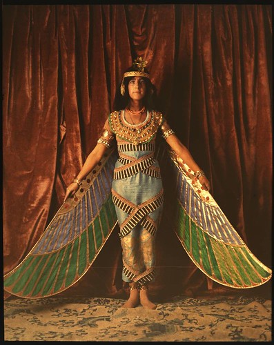 Dancer wearing Egyptian-look costume with wings reaching to the floor