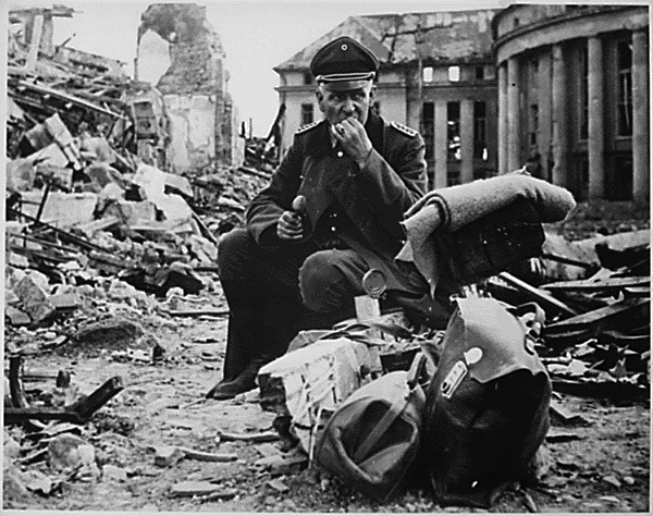 Nazi officer eating a can of C-rations in the ruins of Saarbrucken