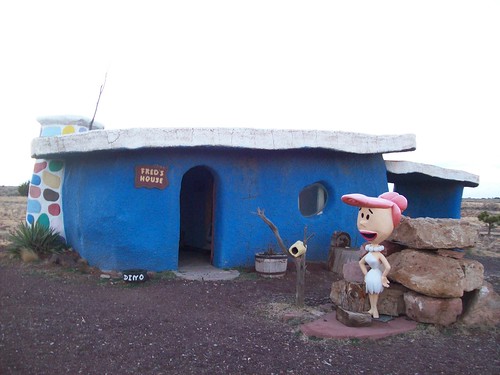 Wilma Flintstone standing in front of Fred's House in the fading sunlight at the tourist trap of Bedrock City, Arizona (bedrock32xy)