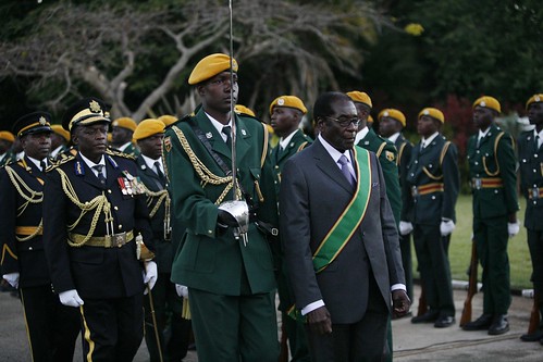 President Robert Mugabe of Zimbabwe with his military forces. The ruling ZANU-PF party negotiated with the opposition to form a national unity government in Harare. by Pan-African News Wire File Photos