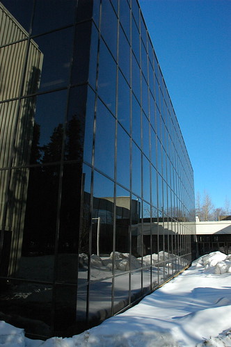 Reflection of the snow and blue sky in the black glass, modern architecture, Consortium Library Exterior, architect Roland H. Lane, University of Alaska, campus, Anchorage, Alaska, USA by Wonderlane