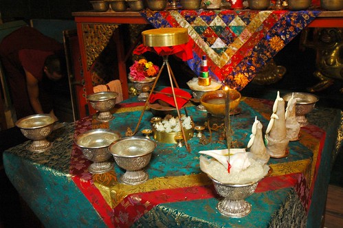 Vajrayogini Empowerment Torma with sindhura powder, ritual spoon, rice heaps, tripod, skullcup, saffron nectar, and candles for diety offering on silk, shrine, Tharlam Monastery, Boudha, Kathmandu, Nepal