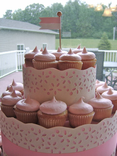 Order a smaller wedding cake and use a cupcake tree for the centerpiece