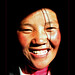 smiling-tibetan-girl-coming-out-darkb
