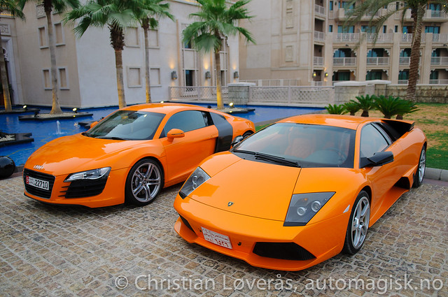 Two orange supercars An Audi R8 and a Lamborghini Murcielago LP640