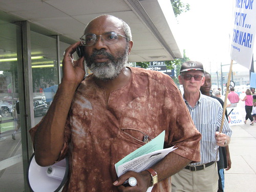 PANW editor, Abayomi Azikiwe, takes call during the Aug. 1, 2008 No War on Iran demonstration in downtown Detroit. The action was organized by MECAWI. (Photo: Alan Pollock). by Pan-African News Wire File Photos