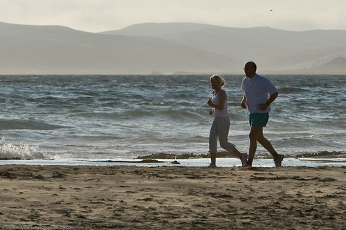 Father-daughter joggers on Morro Strand State Beach, Morro Bay, CA