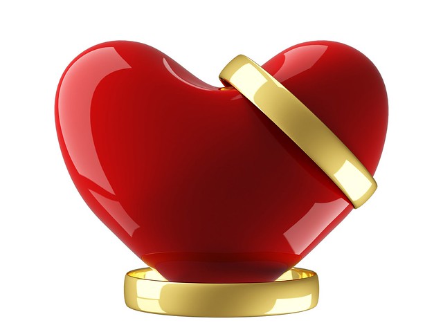 Heart with wedding rings on a white background 3D image