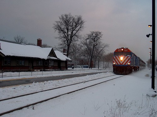 Westbound Metra express commuter train passing the Norwood Park. Metra commuter rail station. Chicago Illinois. Friday, December 1st, 2006 Chicago snowstorm. by Eddie from Chicago