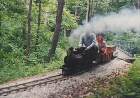 7 and 1/2 " guage steam train rounding a curve in the woods. The Hesston Steam Museum. Hesston Indiana USA. June 1994. by Eddie from Chicago