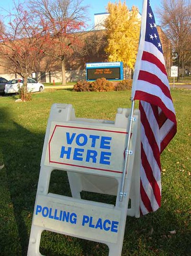 American flag and voting sign