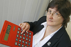 Phot of helpful accountant with large red calculator