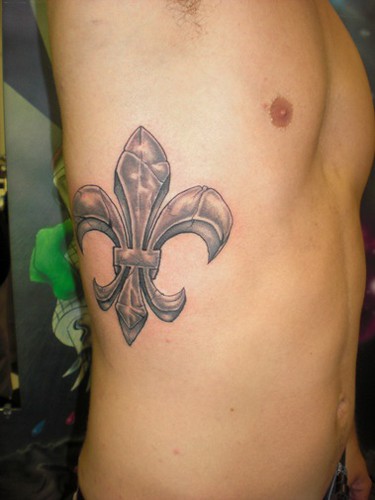 Fleur de lis tattoo on my ribs Its my first one and i've been wanting it 