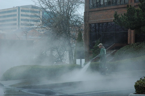 Working, steam cleaning the street in the rain, Seattle, Washington, USA by Wonderlane