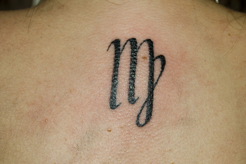 Virgo star sign on the back of a neck