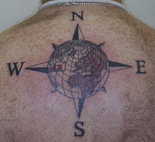 tattoo of the world with compass rose surround done by russell at bizarre 