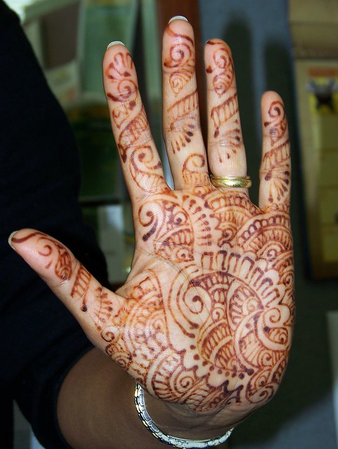A henna tattoo decorated hand done at a recent Indian wedding