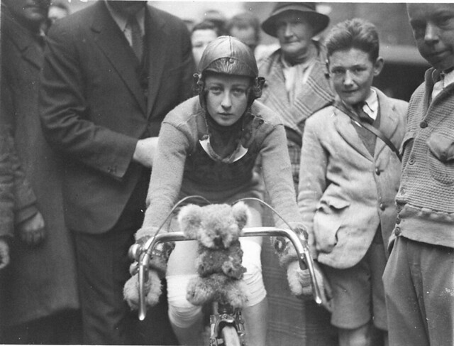 Close-up of Billie Samuels on the Malvern Star bike showing her koala bear mascot before leaving for Melbourne, 4 July 1934, by Sam Hood