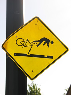 sign: bicyclists watch out for rail tracks