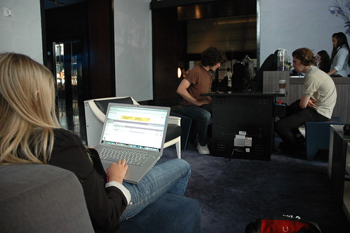 Laptop user, two young men playing a digital game, W Hotel, San Francisco, California, USA