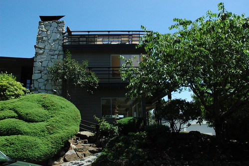 White stone fireplace exterior, walkways, big view windows, topiary, trees, Greenlake, Seattle, Washington, USA by Wonderlane