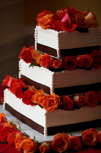 An orange red and brown wedding cake Image by Regeti 39s Photography