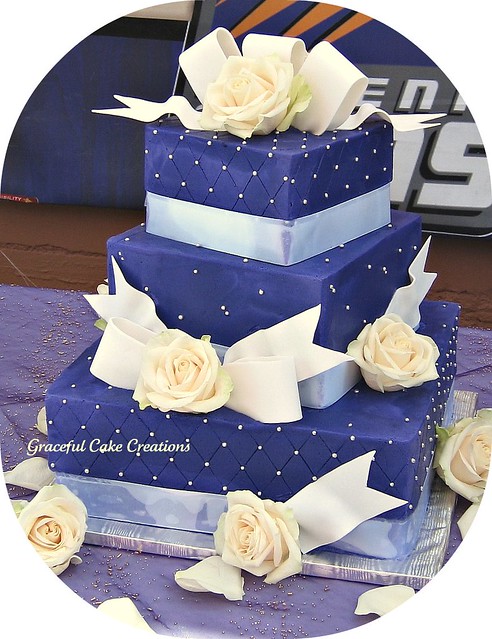 Square wedding cake iced in purple butter cream with a quilting pattern 