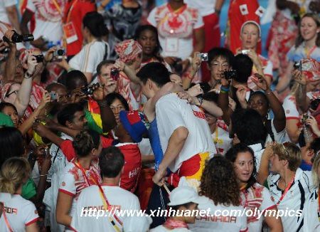 August 24th, 2008 - Yao Ming is hugged by Australian basketball player Lauren Jackson at the Closing Ceremonies of the Olympic Games