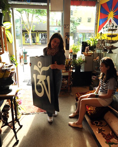 Marguerite Tingkhye carries the Tibetan letter Om sign, family store Pema Kharpo - White Flower, her daughter watches, Tibetan Buddhist gifts, carpets, statues, furniture, carpets, jewelry, religious items, Greenwood, Seattle, Washington, USA by Wonderlane