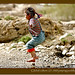 child-jumping-puddles-tibet