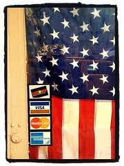 credit card logos and USA flag on shop door
