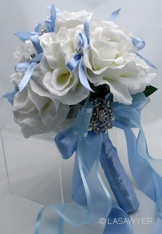 This bouquet is made with white silk roses rhinestone picks and blue satin