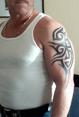 man upper arm tribal tattoo