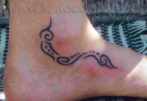 small fine tribal tattoo on ankle I made while travelling in mexico