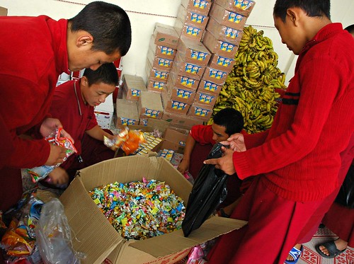Big box of candy for the celebration manga, with several young monks readying the feast, Tharlam Courtyard Stage, Boudha, Kathmandu, Nepal by Wonderlane