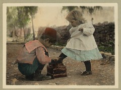 Vintage Picture of Two Children, A Cute Boy giving a Shoe Shine to a Beautiful Little Blonde Girl