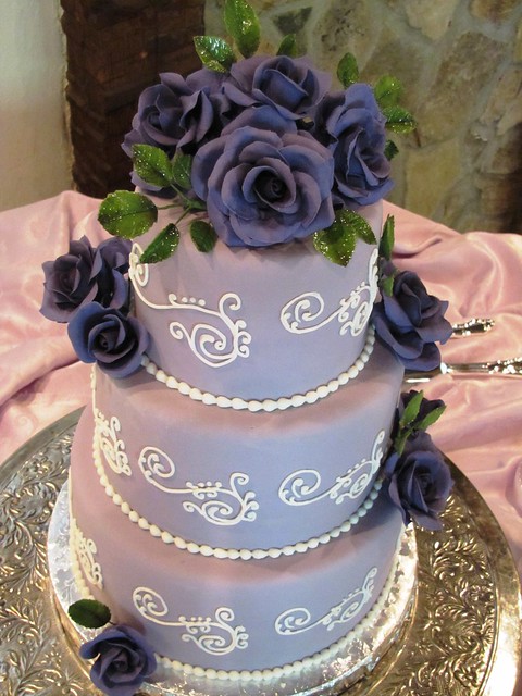 Lavender Wedding Cake with dark purple gumpaste roses and white royal icing