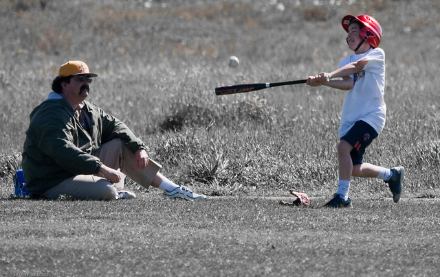 Father and son baseball batting lesson in the Cloisters Park, Morro Bay, CA