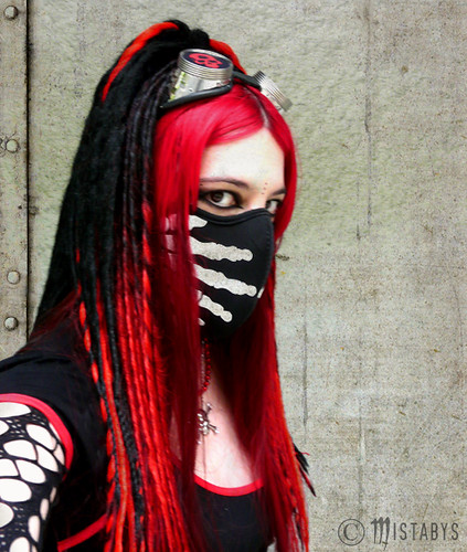 portrait of a goth girl with cyber mask and red goggles on industrial 