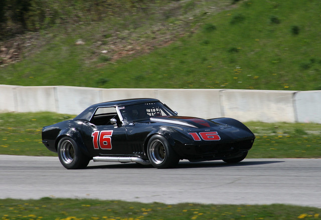 SVRA Vintage Races 1969 Black Corvette coupe at speed at the Bill Mitchell