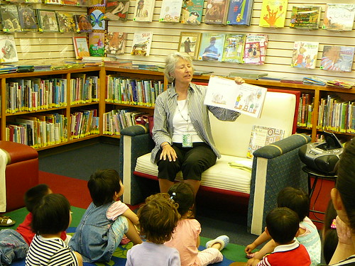 Debbie reading to children during Lapsit Storytime.