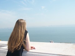 girl gazing out across clear blue skies