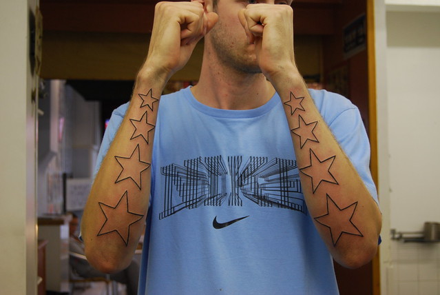 stars on arms tattoo