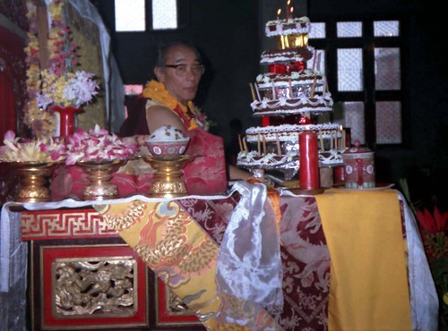 1990 Lam Dre, His Holiness Jigdal Dagchen Sakya Rinpoche with his birthday cake offering mandala, long life rice, and flowers, very fancy silks, with pink, purple, gold dragons, flowers, on his throne, Tharlam Monastery, Boudha, Kathmandu, Nepal by Wonderlane