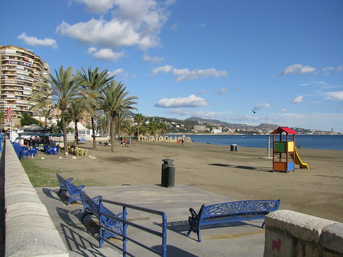 Blue benches on Malagueta Beach, Malaga, Spain