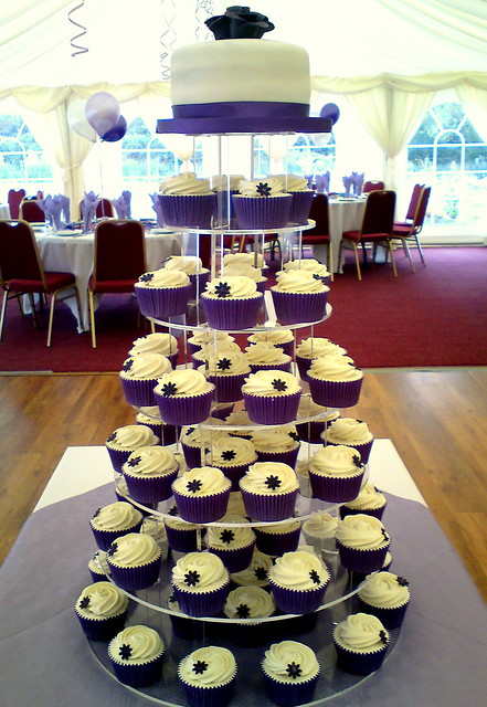 Purple wedding cupcakes and cutting cake