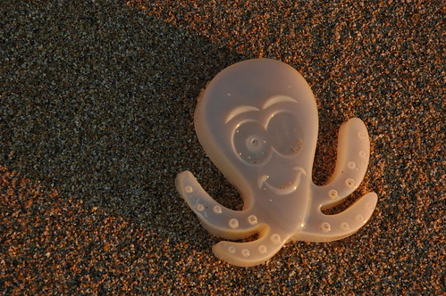 Plastic octopus thrown back by the Pacific Ocean at Gray Whale Cove, California Coast, USA by Wonderlane