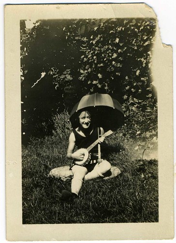 Snapshot: Backyard Woman With Umbrella And Banjo